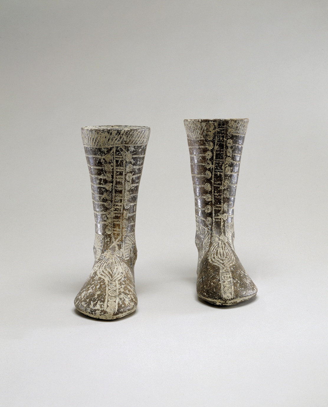 182. Two Votive Boots